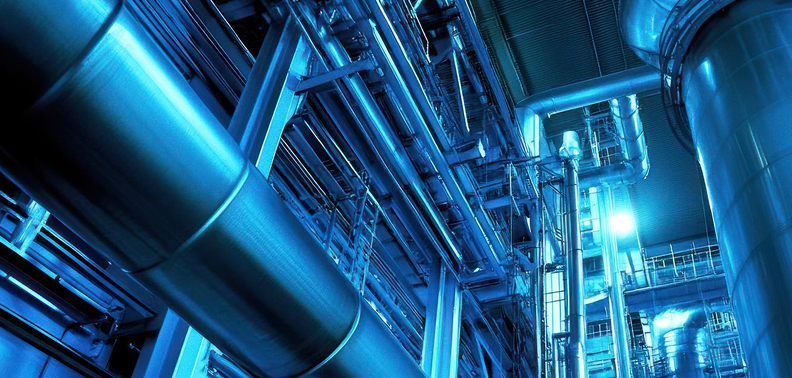 A network of industrial pipes running through a large industrial building, showcasing complex infrastructure and design.