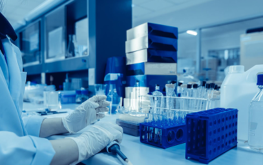 A person in a lab coat is focused on conducting an experiment in a laboratory setting.