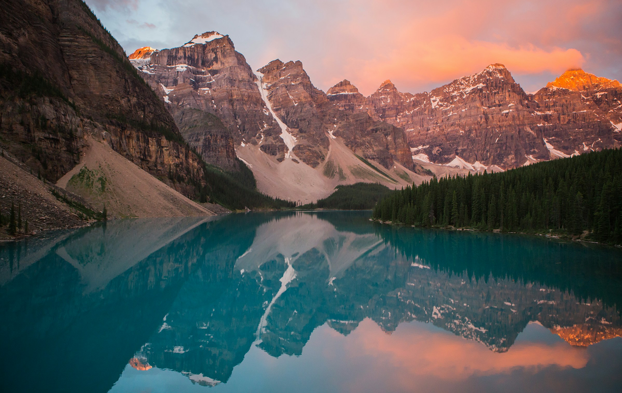 Scenic view of Moraine Lake, nestled in Banff National Park, Alberta, Canada, with vibrant turquoise waters and mountains.
