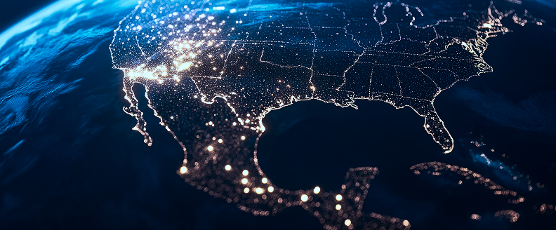 A satellite view of the United States at night, showcasing city lights and illuminated regions across the country.