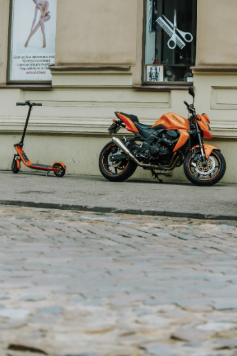 Figure 3: Electronic Scooter side by side a motorcycle, pic courtesy Pexels GmBH.